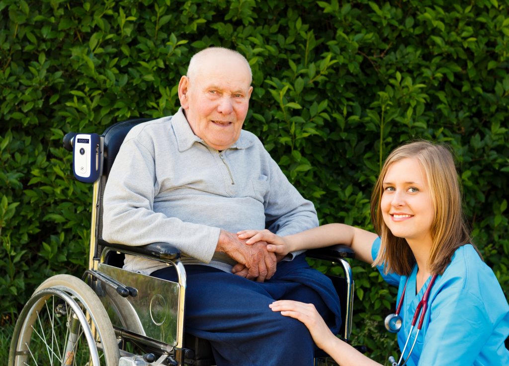 Sensatec_man in wheelchair and nurse_outside_w product_shutterstock_-700-212609410