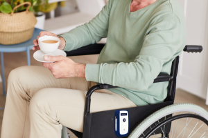 close-up-disabled-man-sitting-wheelchair-with-cup-tea-home