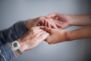 Close up of hands with Quick Response Nurse Call wrist pendant