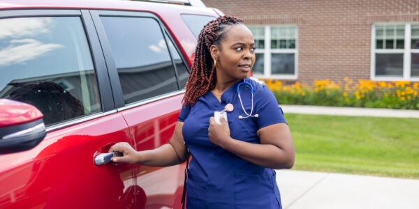 Nurse in parking lot pushing panic button