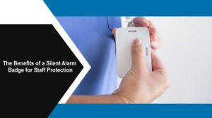 Worker pressing Help Alert silent alarm badge button