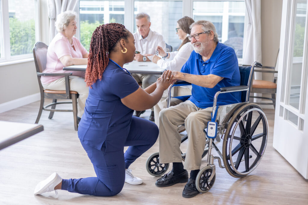 Sensatec fall device on wheelchair with nurse helping